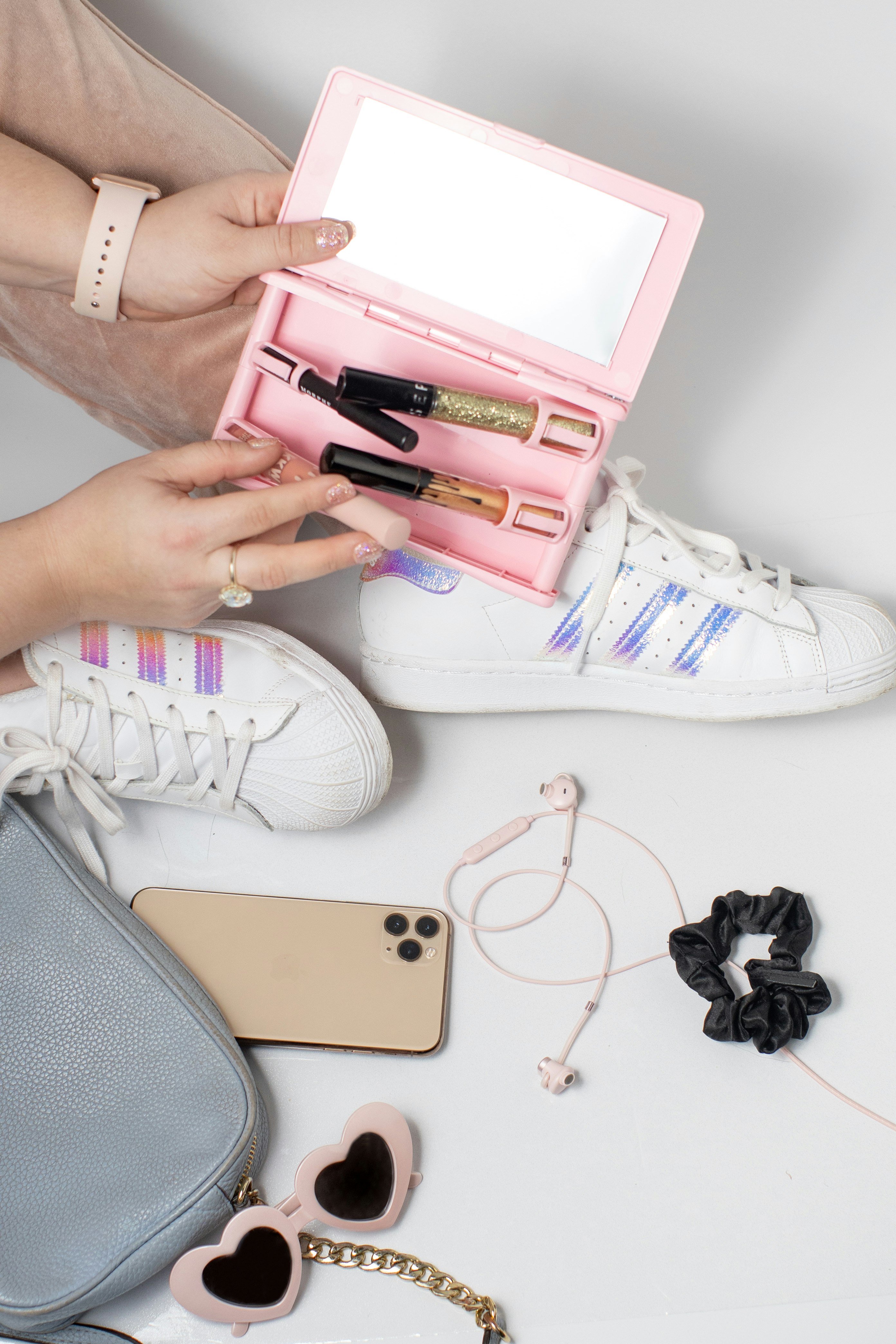 person holding pink and white wallet